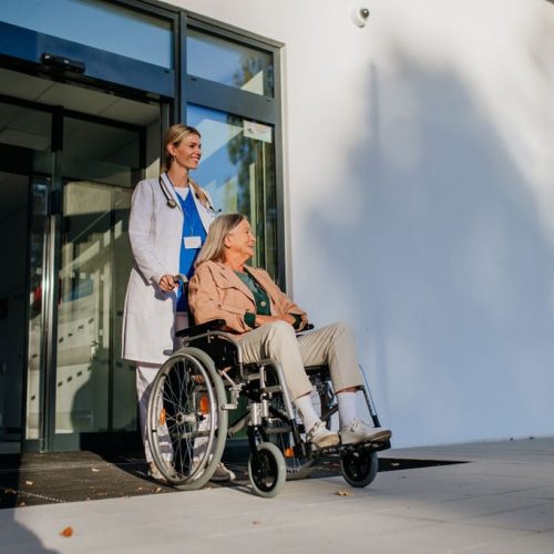 young woman doctor taking care of senior woman